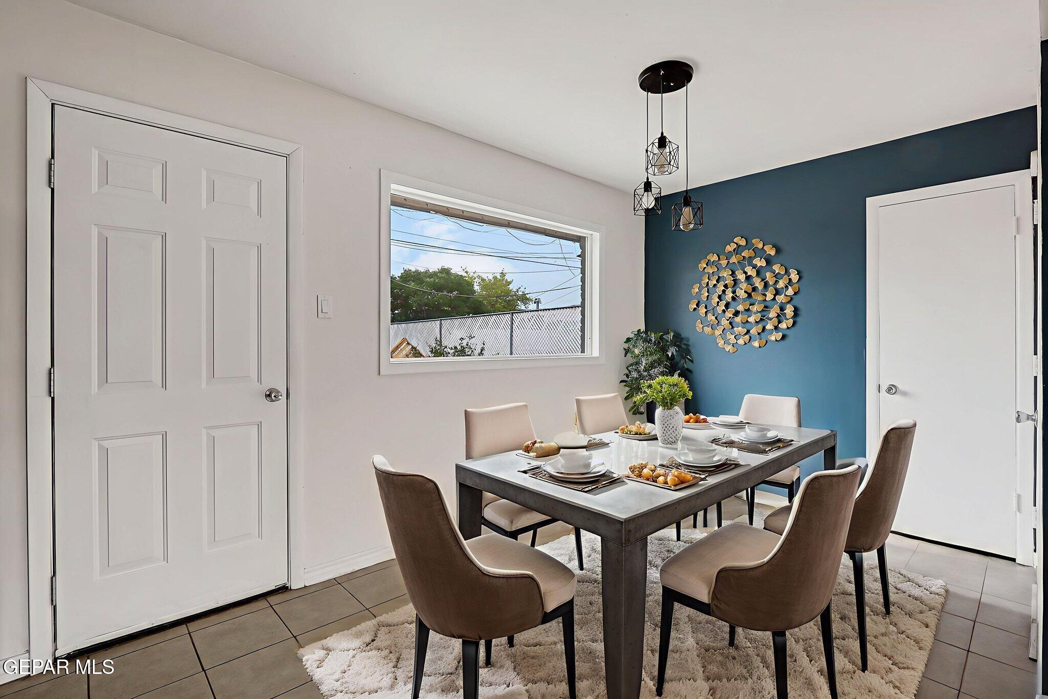 4956 Rutherford Drive El Paso, TX 79924 - Photo 4 of 41 a view of a dining room with furniture window and wooden floor