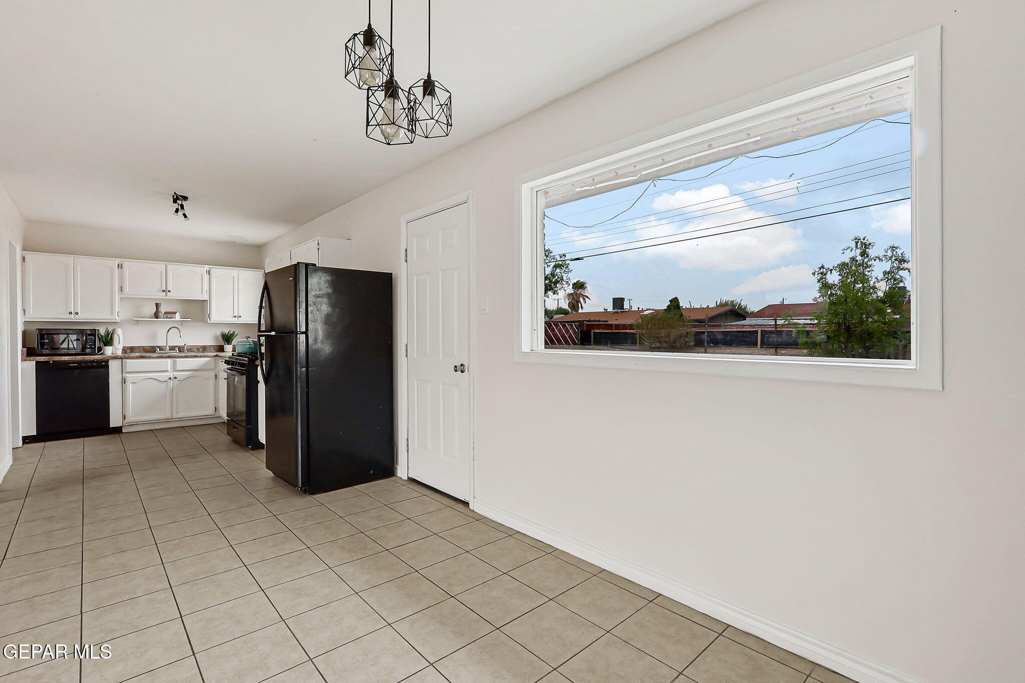 4956 Rutherford Drive El Paso, TX 79924 - Photo 5 of 41 a kitchen with stainless steel appliances a refrigerator and a microwave