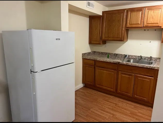 a white refrigerator freezer sitting inside of a kitchen