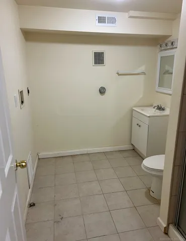a bathroom with a granite countertop toilet a sink and a mirror