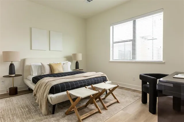 a bedroom with a bed a desk and chair