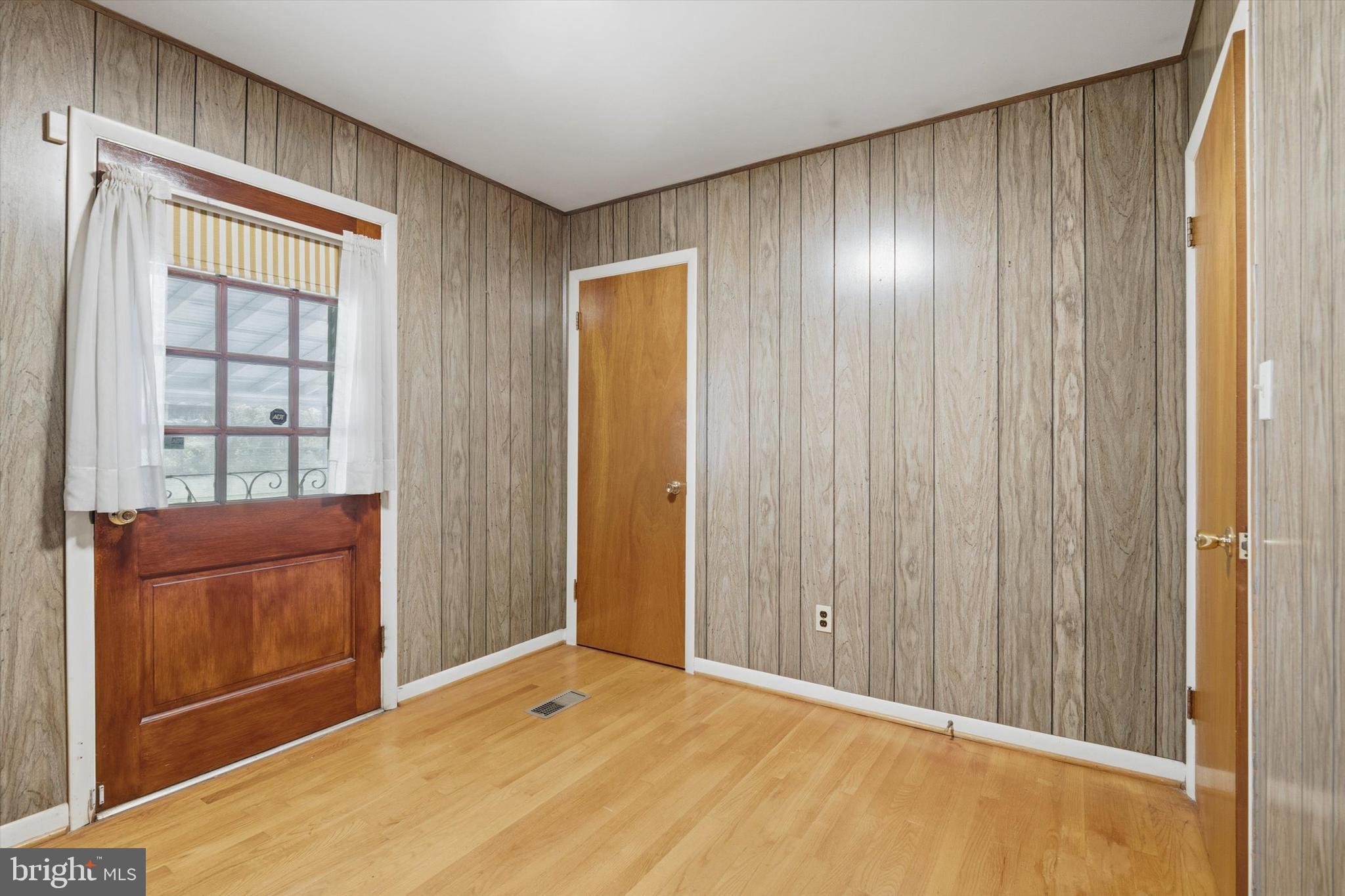 697 West Maple Road Linthicum Heights, MD 21090 - Photo 23 of 36 a view of an empty room with wooden floor and a window