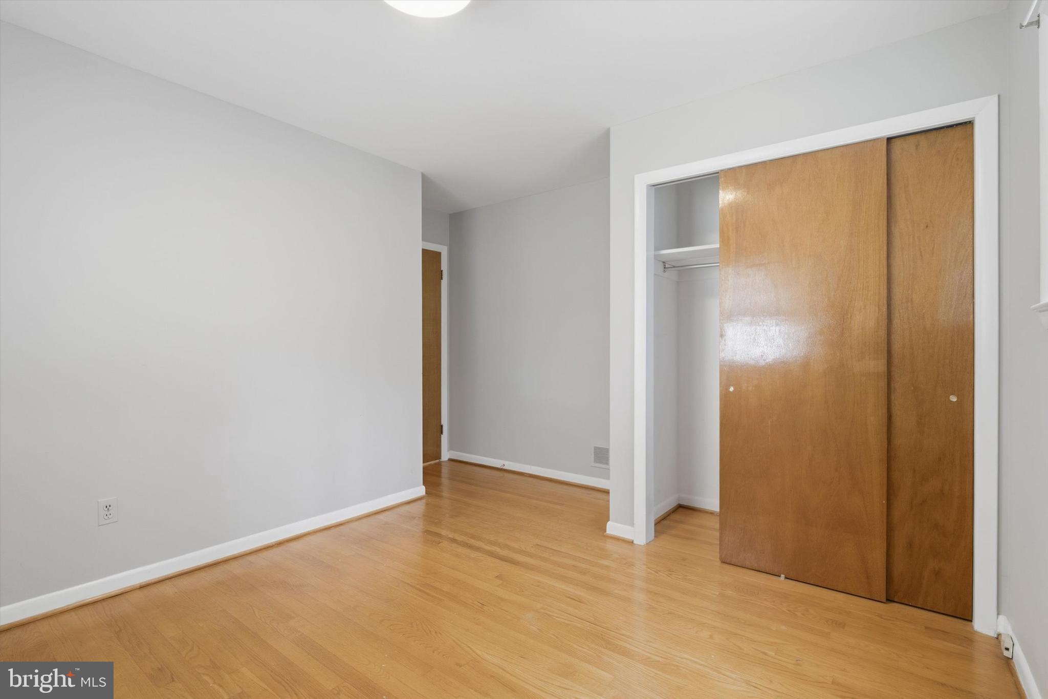 697 West Maple Road Linthicum Heights, MD 21090 - Photo 25 of 36 a view of an empty room with wooden floor and a window