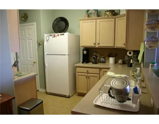 a kitchen with a refrigerator and a stove