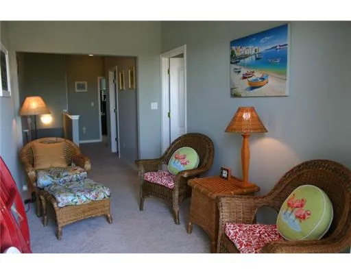 a living room with furniture and a mirror