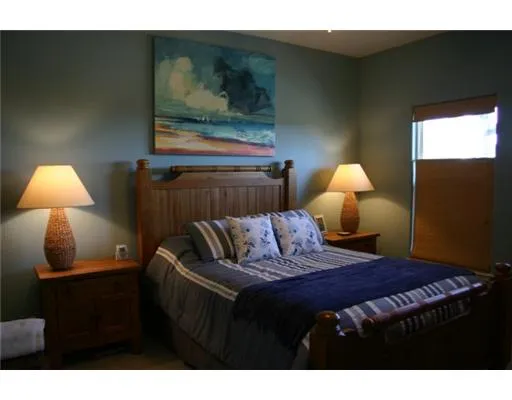 a bedroom with a bed and a lamp