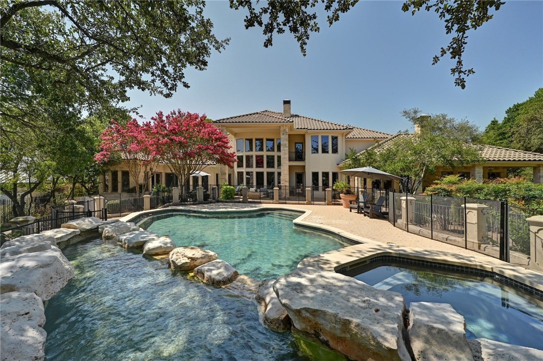 a view of a house with backyard patio and swimming pool