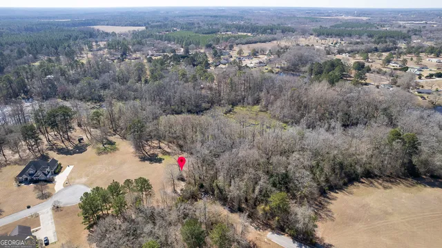 an aerial view of residential house and car parked