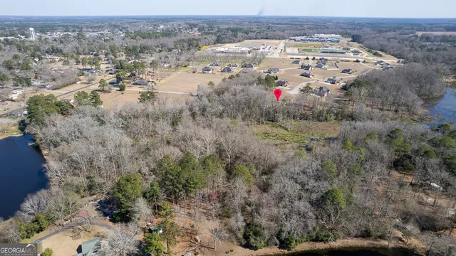 an aerial view of house with yard and mountain view in back