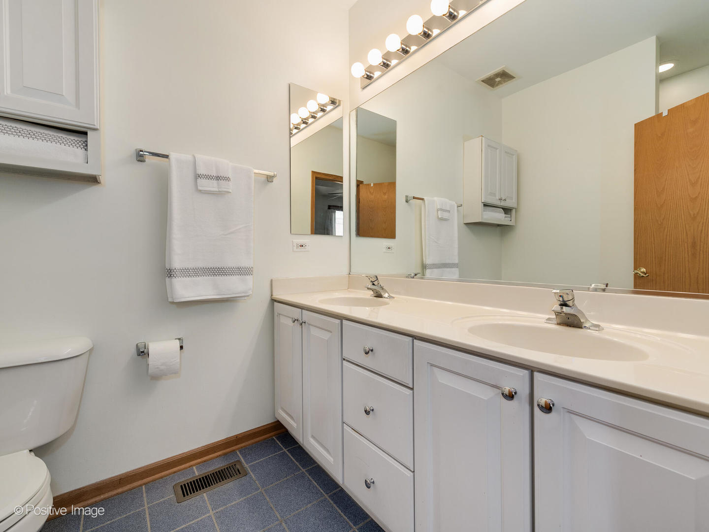 1215 West Lexington Street, Unit E Chicago, IL 60607 - Photo 12 of 21 a bathroom with a granite countertop sink mirror and toilet