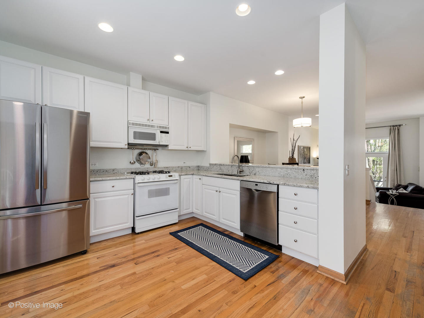 1215 West Lexington Street, Unit E Chicago, IL 60607 - Photo 8 of 21 a kitchen with white cabinets and stainless steel appliances