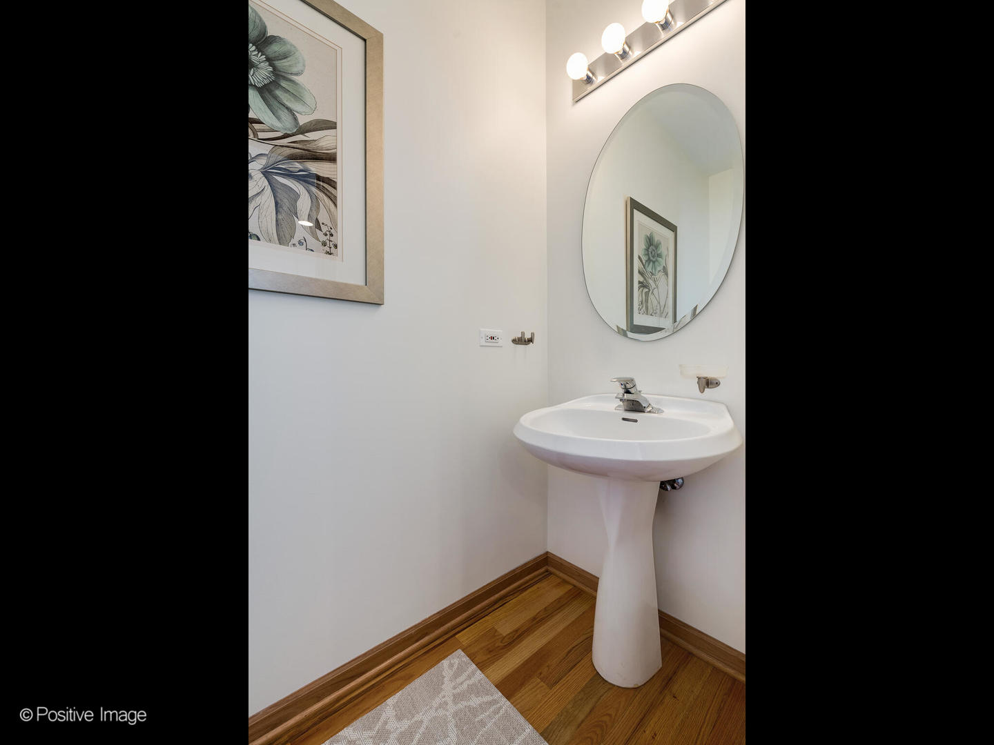 1215 West Lexington Street, Unit E Chicago, IL 60607 - Photo 10 of 21 a bathroom with a sink and a mirror