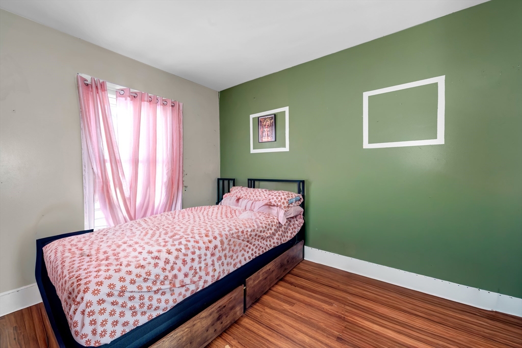 103 Ash Street Nashua, NH 03060 - Photo 11 of 36 a bedroom with a bed and wooden floor