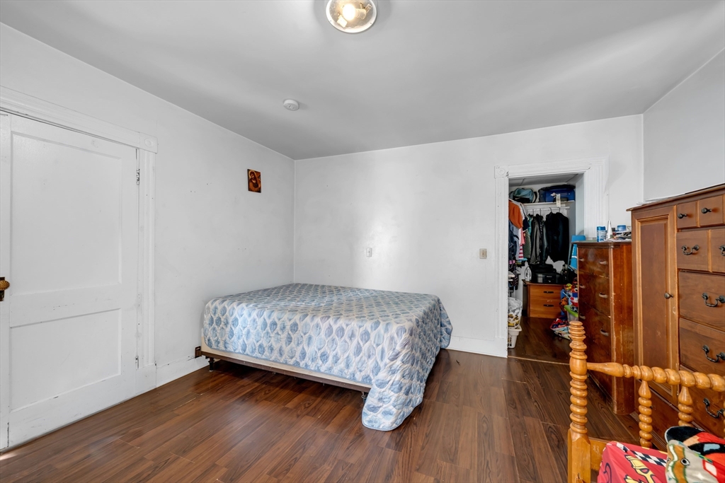 103 Ash Street Nashua, NH 03060 - Photo 12 of 36 a bedroom with a bed and a walk in closet