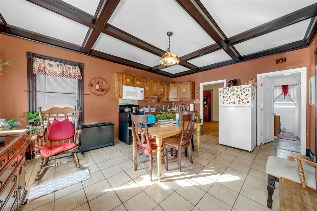 103 Ash Street Nashua, NH 03060 - Photo 13 of 36 a room with stainless steel appliances kitchen island granite countertop furniture and a chandelier
