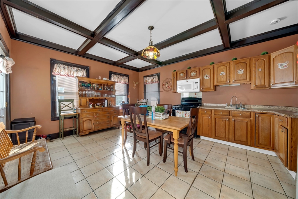 103 Ash Street Nashua, NH 03060 - Photo 14 of 36 a dining hall with stainless steel appliances granite countertop a stove and cabinets