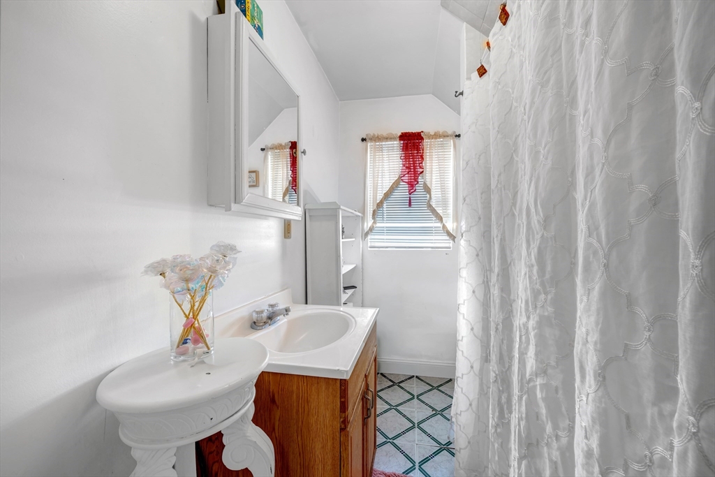 103 Ash Street Nashua, NH 03060 - Photo 16 of 36 a bathroom with a sink toilet and mirror