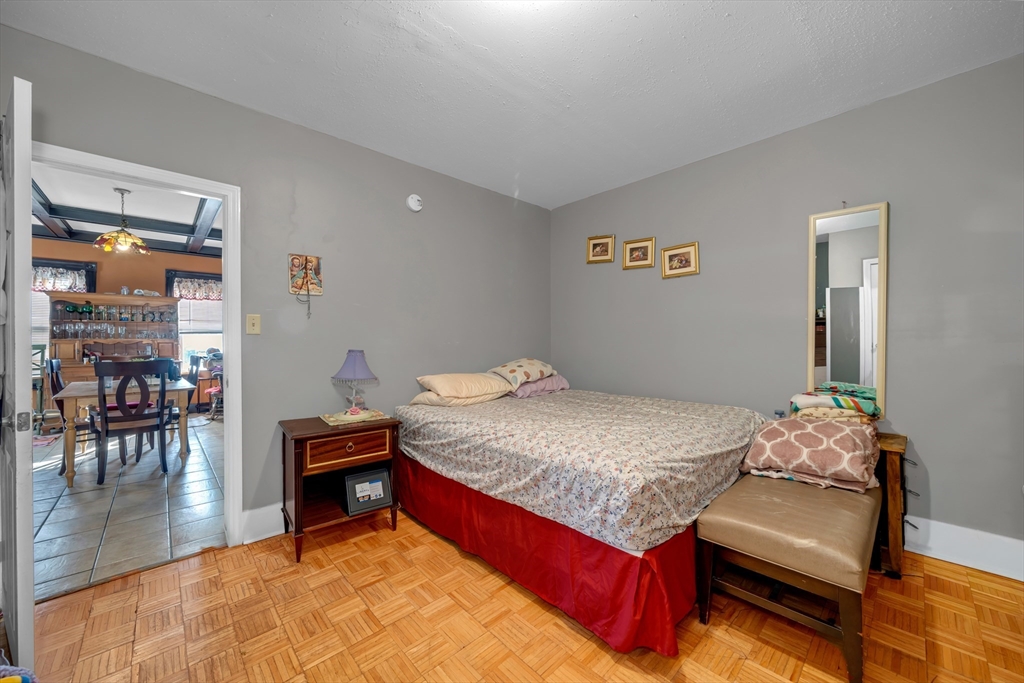 103 Ash Street Nashua, NH 03060 - Photo 17 of 36 a bed room with a bed and a chair