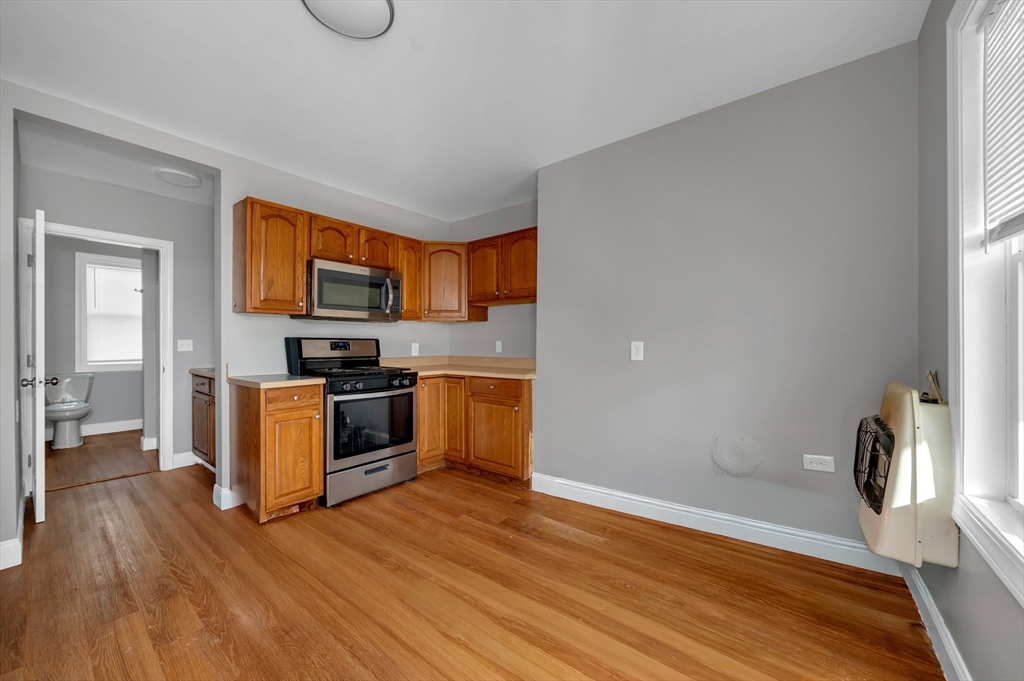 103 Ash Street Nashua, NH 03060 - Photo 18 of 36 a kitchen with granite countertop a stove and a refrigerator