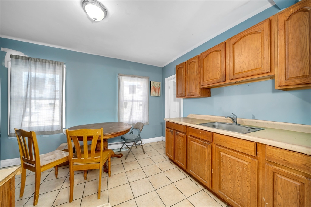 103 Ash Street Nashua, NH 03060 - Photo 23 of 36 a dining room with stainless steel appliances a sink window and cabinets