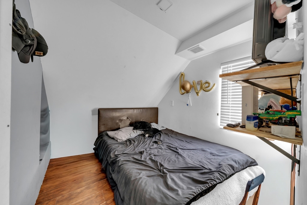 103 Ash Street Nashua, NH 03060 - Photo 29 of 36 a bed sitting in a bedroom next to a window