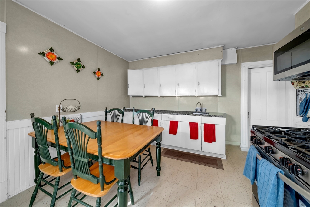 103 Ash Street Nashua, NH 03060 - Photo 6 of 36 a kitchen with stainless steel appliances granite countertop a stove a sink and a refrigerator