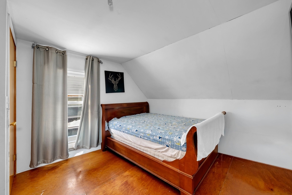 103 Ash Street Nashua, NH 03060 - Photo 7 of 36 a bedroom with a bed and a window