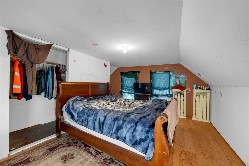 103 Ash Street Nashua, NH 03060 - Photo 9 of 36 a bedroom with furniture and a baby crib