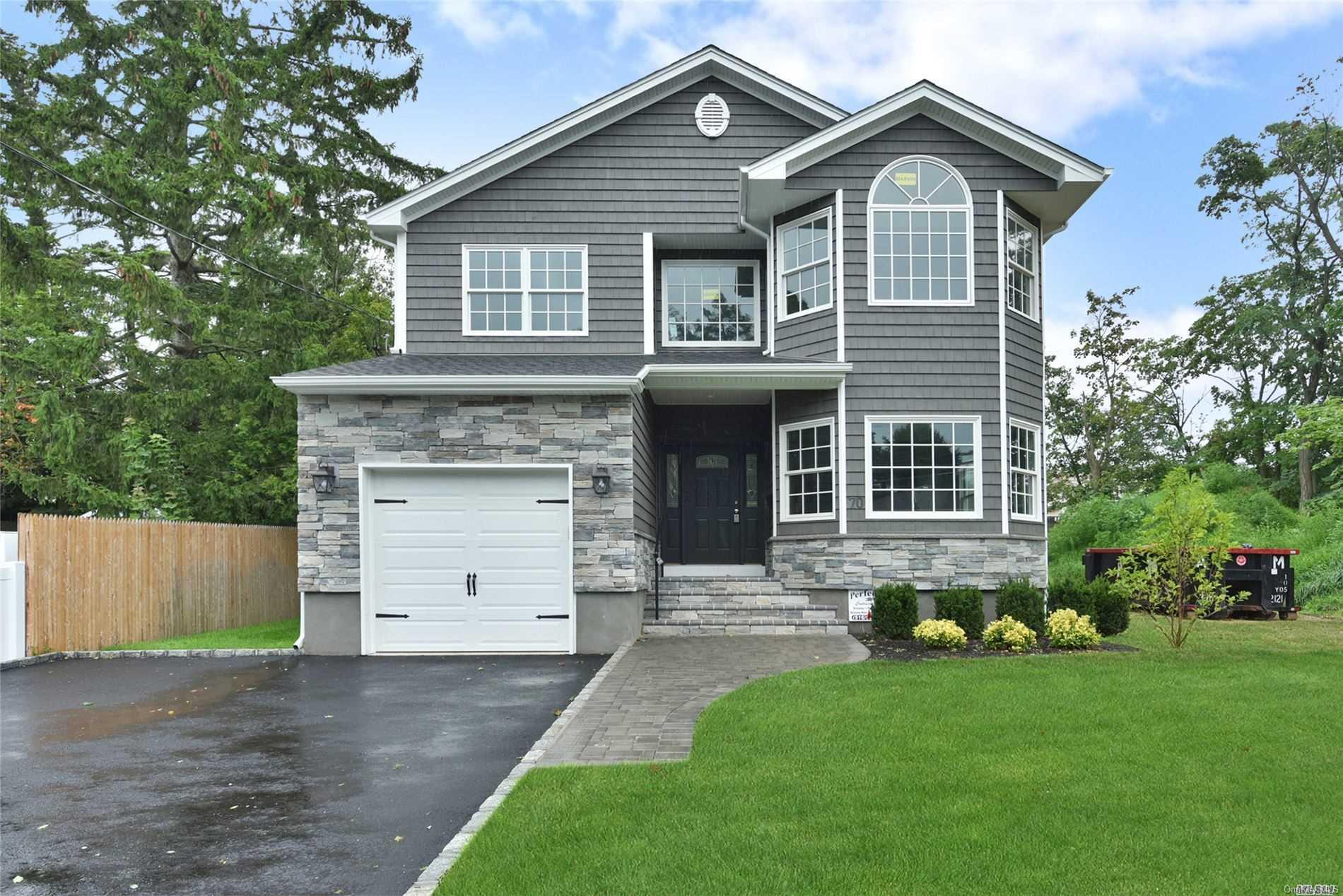 70 Split Rock Road Syosset, NY 11791 - Photo 1 of 1 a front view of a house with a yard and garage