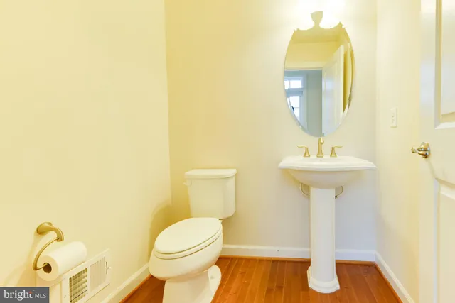a view of a big room with windows and chandelier