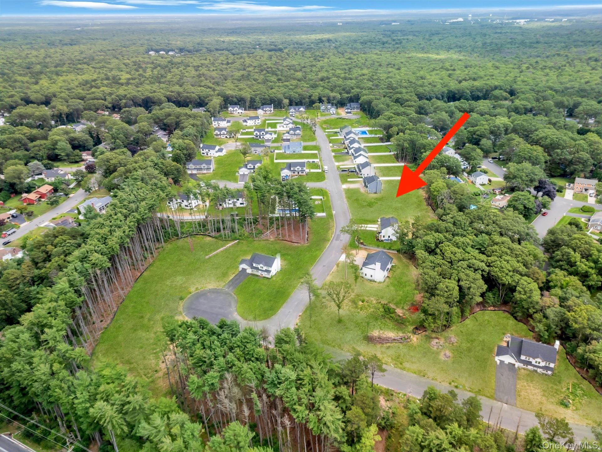 Lot #36 Fox Run Court Ridge, NY 11961 - Photo 6 of 17 a view of a lake with a houses