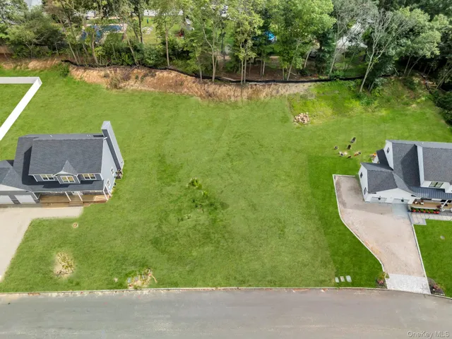 a front view of a house with a garden and trees