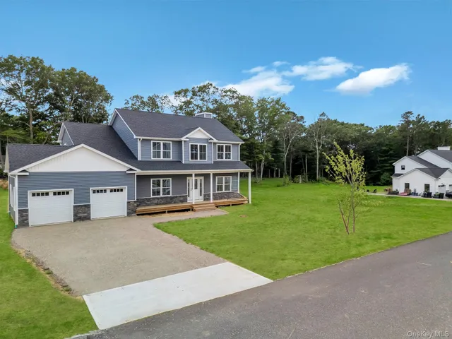 a front view of a house with a garden and yard