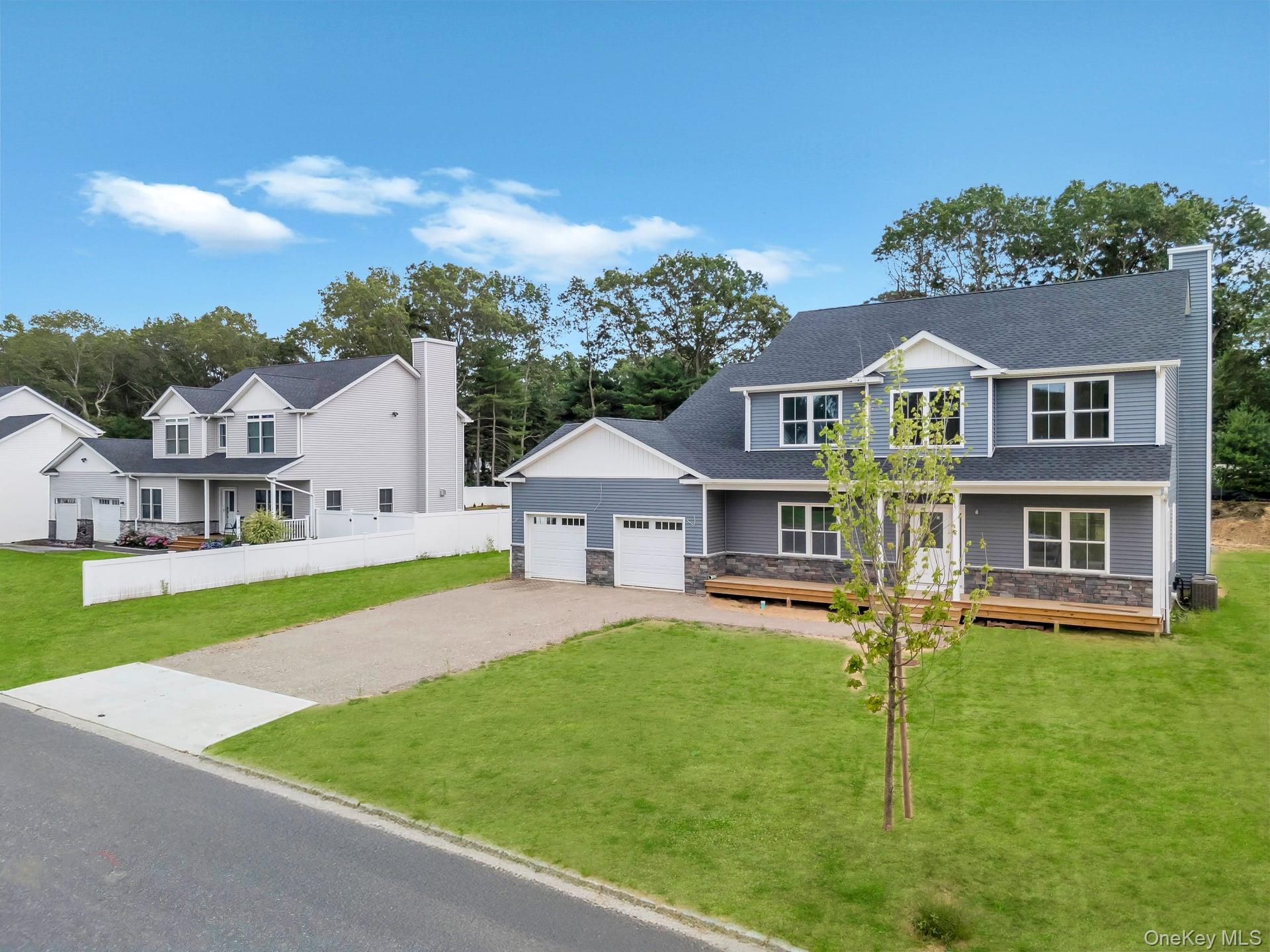 Lot #36 Fox Run Court Ridge, NY 11961 - Photo 10 of 17 a front view of a house with a garden and yard