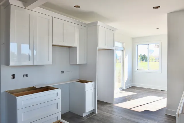 a kitchen with stainless steel appliances granite countertop a sink a stove and a refrigerator