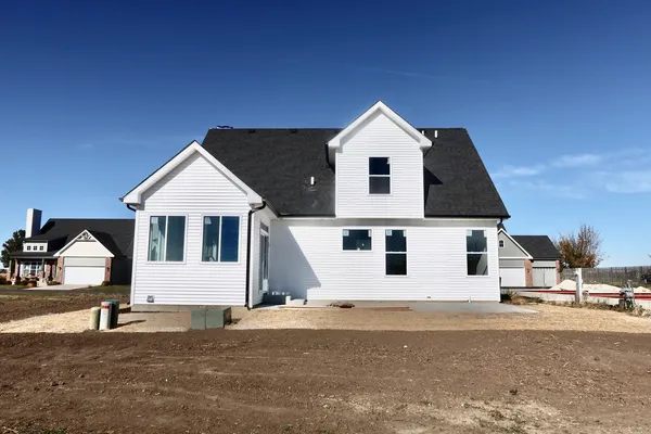 a view of a white house with a yard