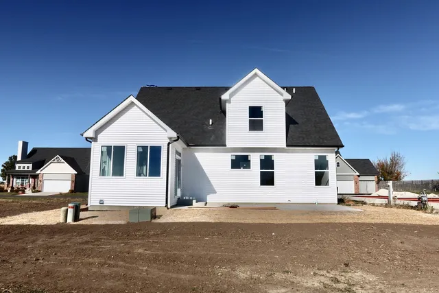 a view of a white house with a yard