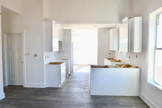 a large white kitchen with a sink a stove and a refrigerator