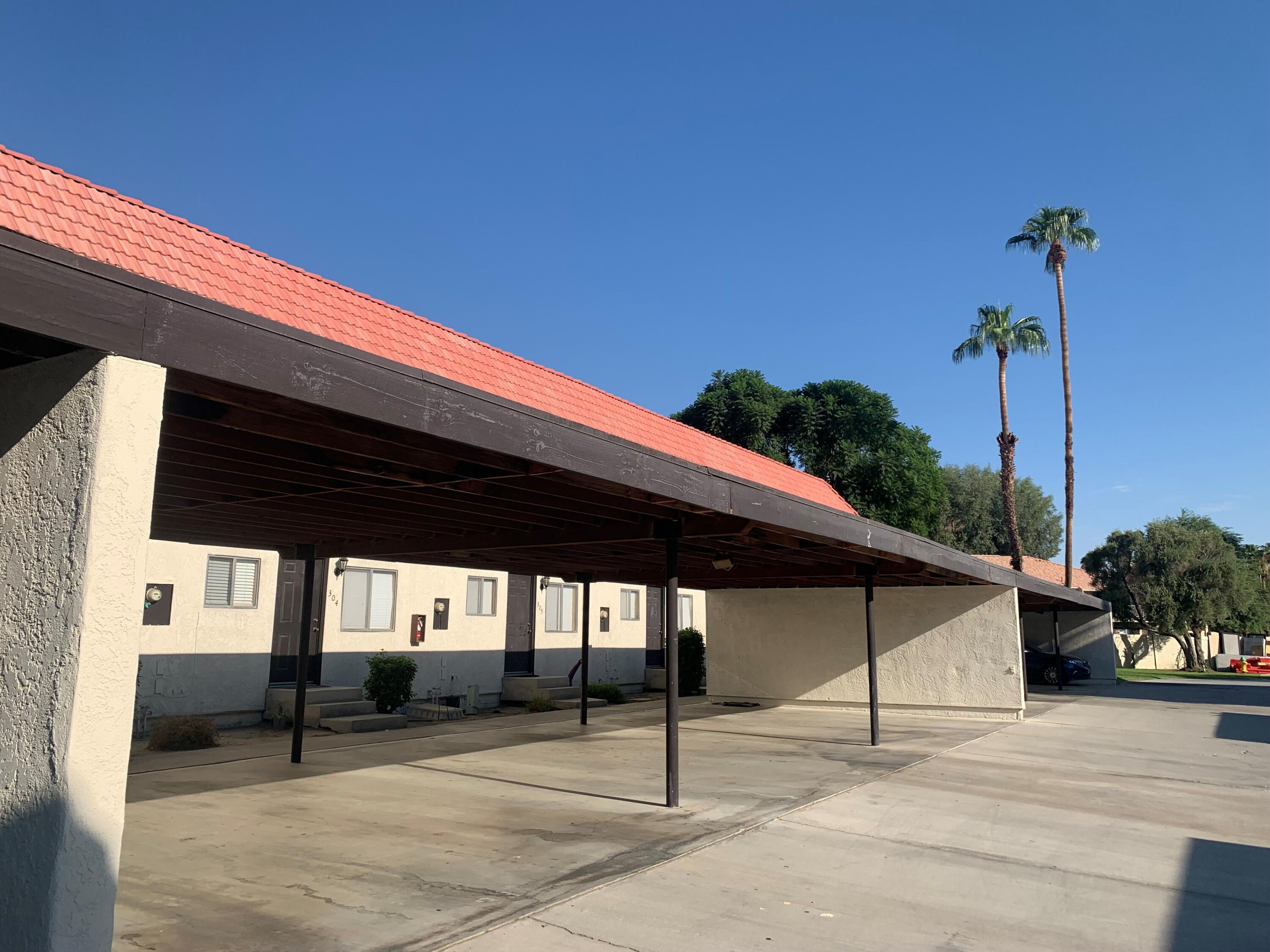 40225 Harris Lane, Unit 304 Palm Desert, CA 92211 - Photo 11 of 14 a patio with table and chairs and potted plants