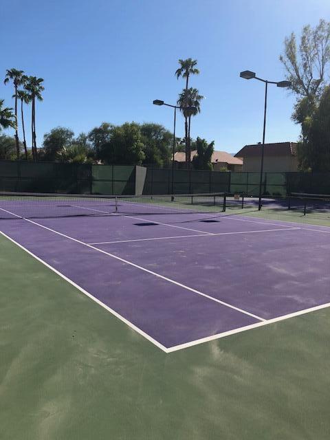 40225 Harris Lane, Unit 304 Palm Desert, CA 92211 - Photo 13 of 14 a tennis court that has a tree in the background