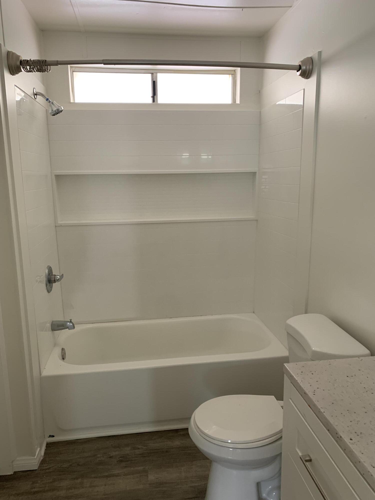 40225 Harris Lane, Unit 304 Palm Desert, CA 92211 - Photo 8 of 14 a bathroom with a toilet and a bathtub