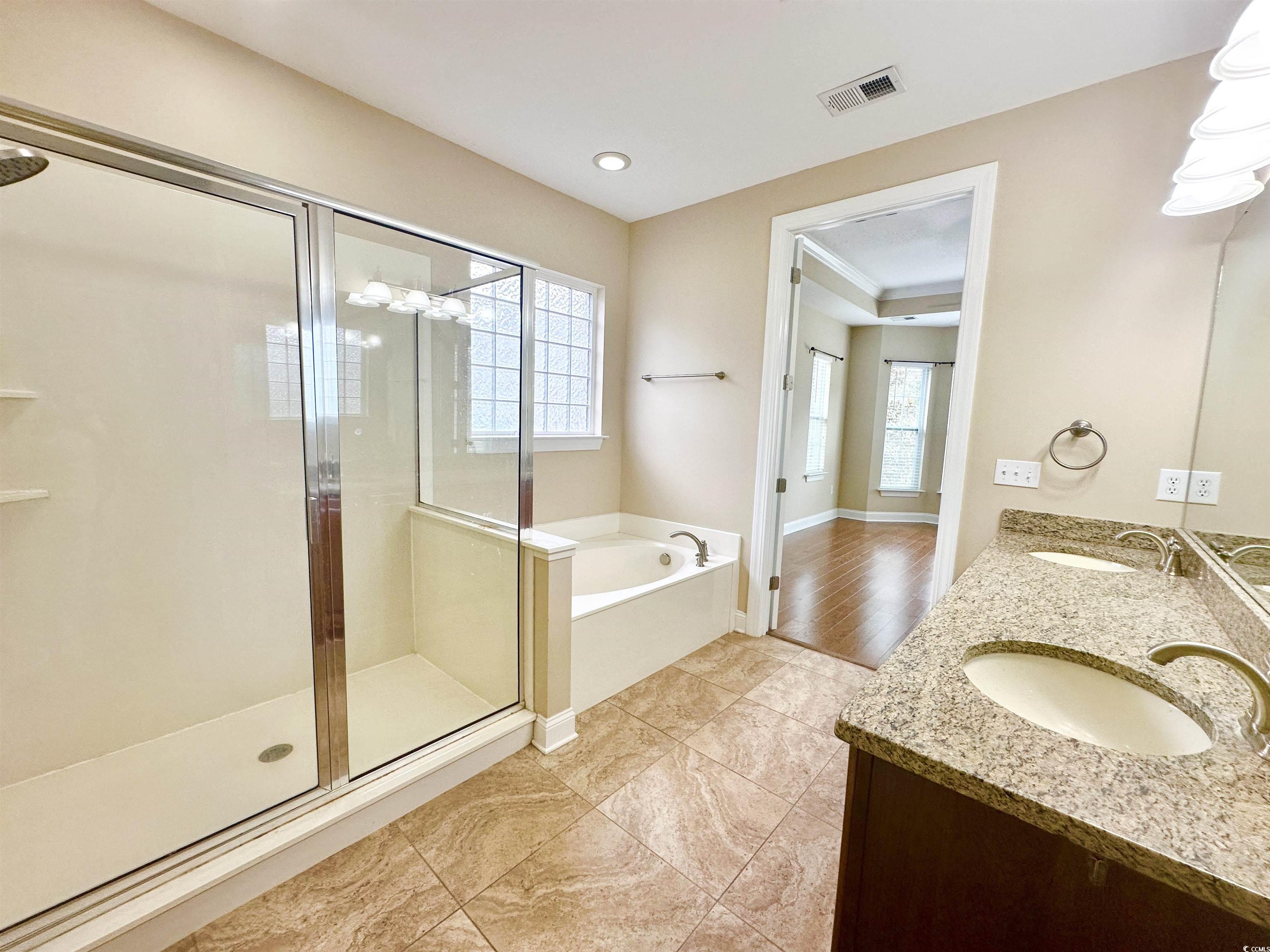 8472 Juxa Drive Myrtle Beach, SC 29579 - Photo 20 of 35 Full bathroom featuring a garden tub, healthy amount of natural light, double vanity, and a stall shower