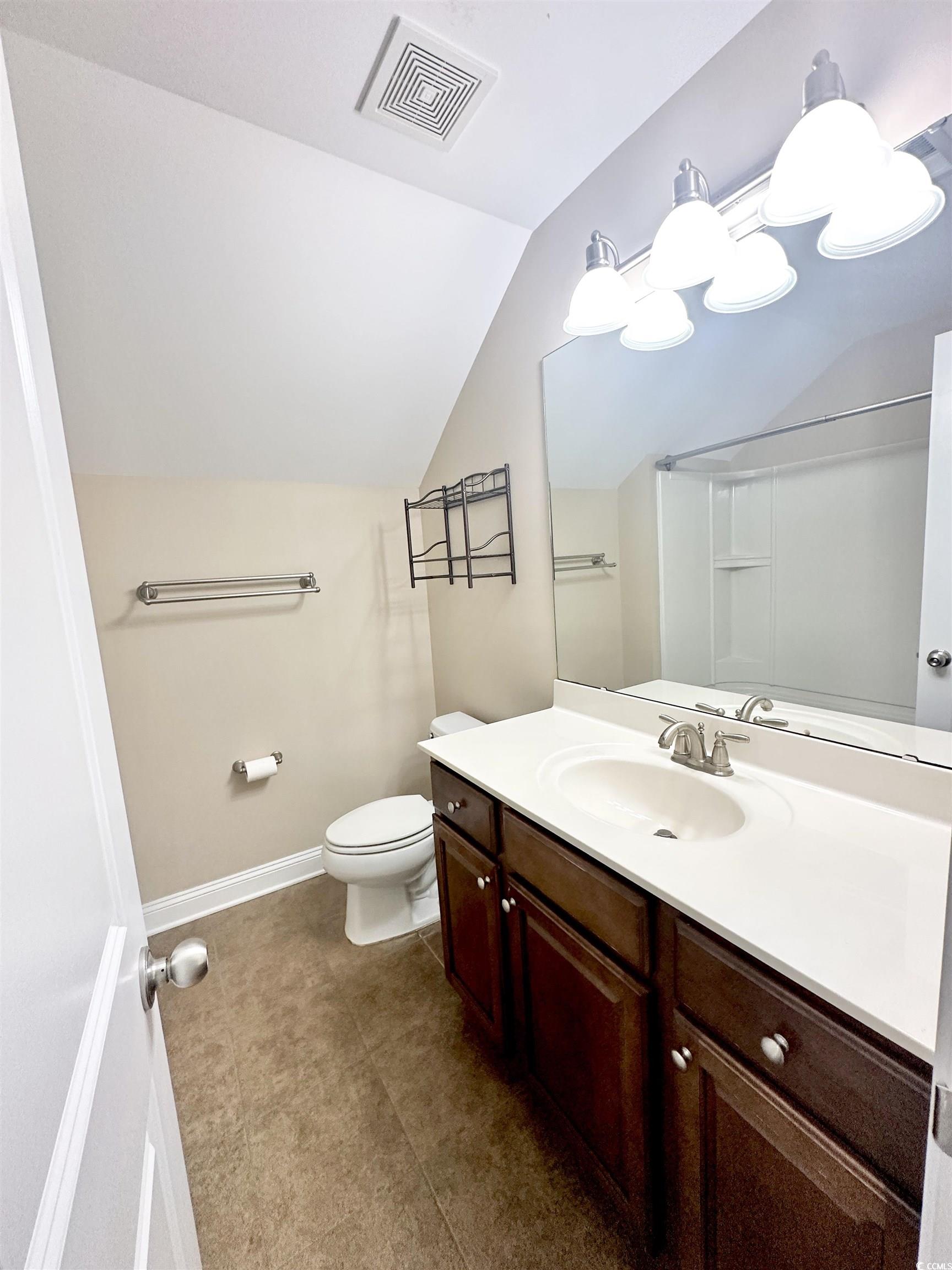 8472 Juxa Drive Myrtle Beach, SC 29579 - Photo 25 of 35 Bathroom featuring lofted ceiling and vanity