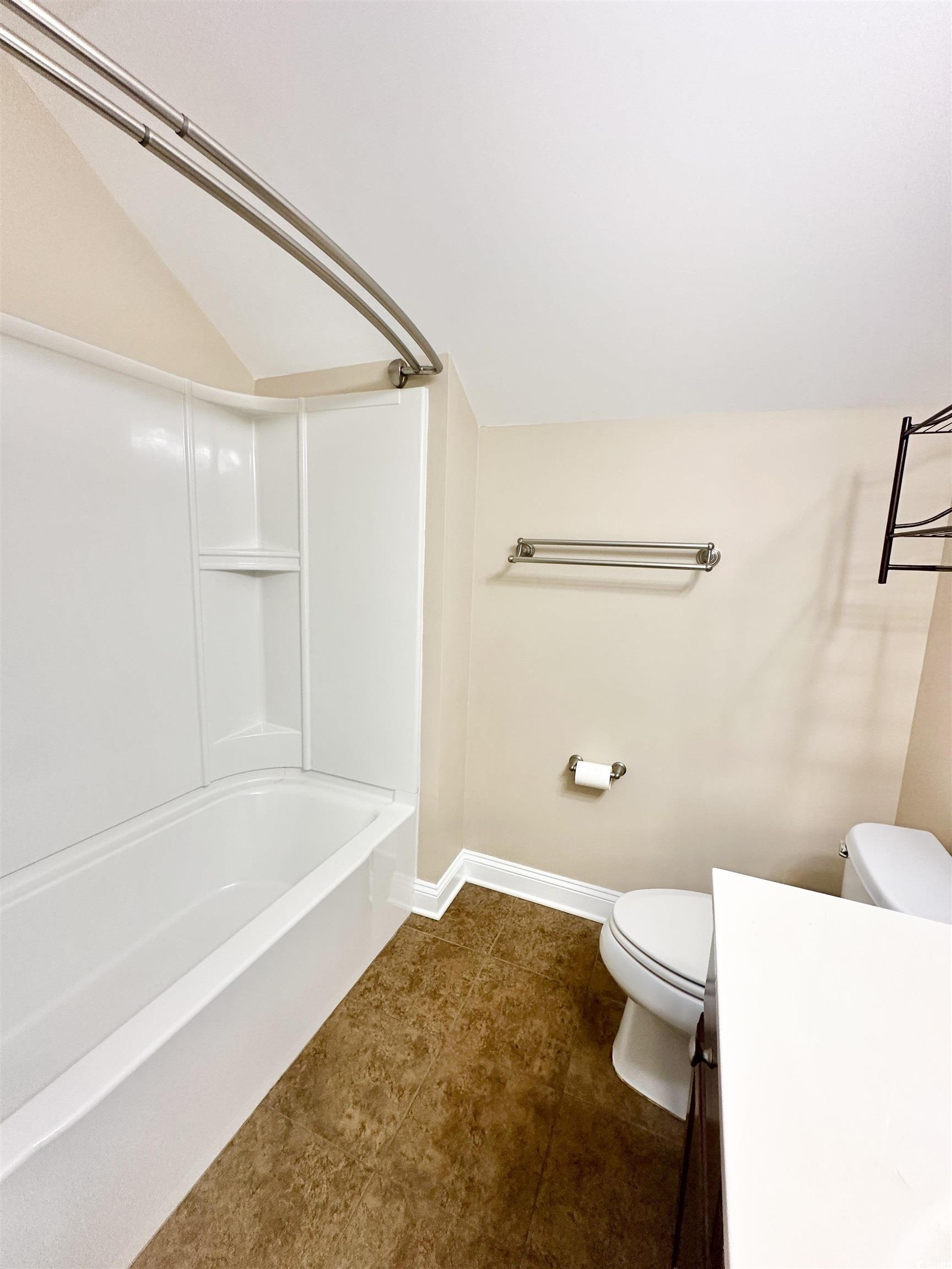 8472 Juxa Drive Myrtle Beach, SC 29579 - Photo 26 of 35 Full bathroom with bathing tub / shower combination, lofted ceiling, vanity, and dark tile patterned flooring
