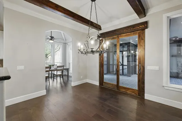 a view of a livingroom kitchen and hall with wooden floor