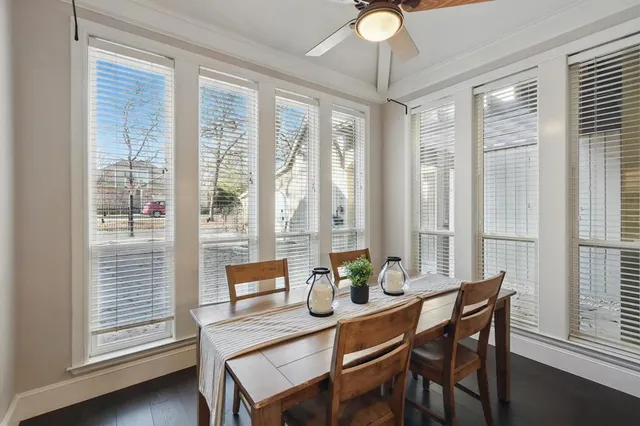 a dining room with furniture a chandelier and wooden floor