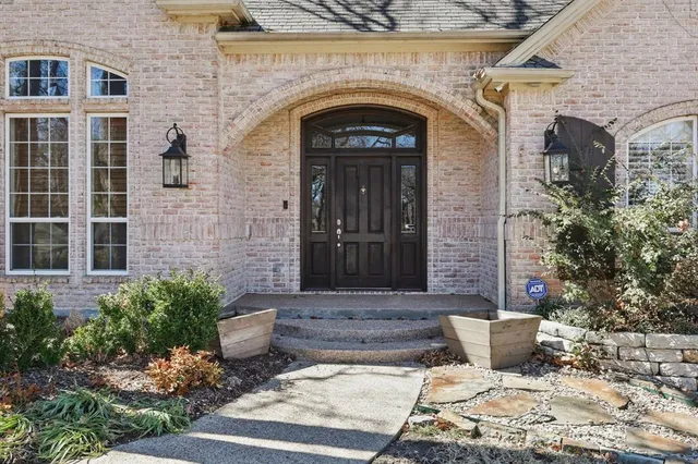a view of a stone house with potted plants