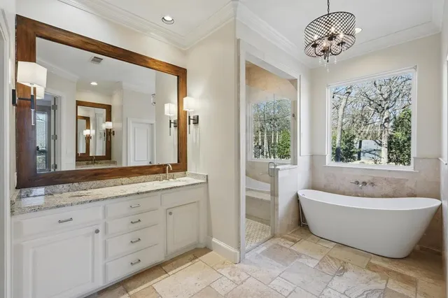 a spacious bathroom with a double vanity sink and a bathtub
