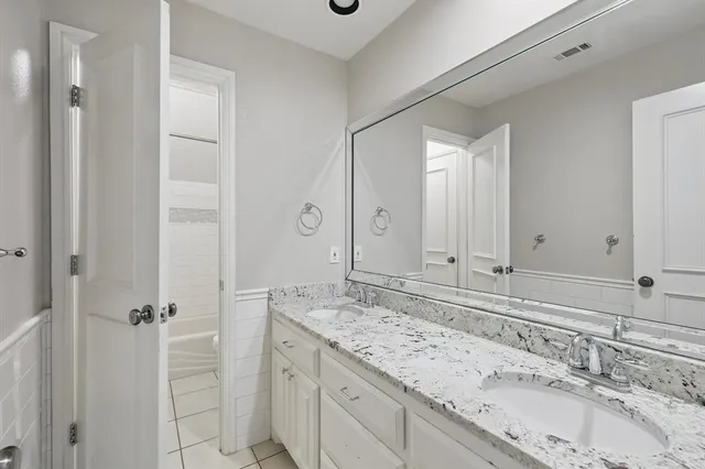 a bathroom with a granite countertop sink mirror and double