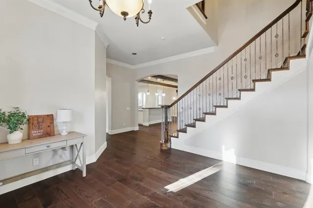 a view of entryway and hall with wooden floor